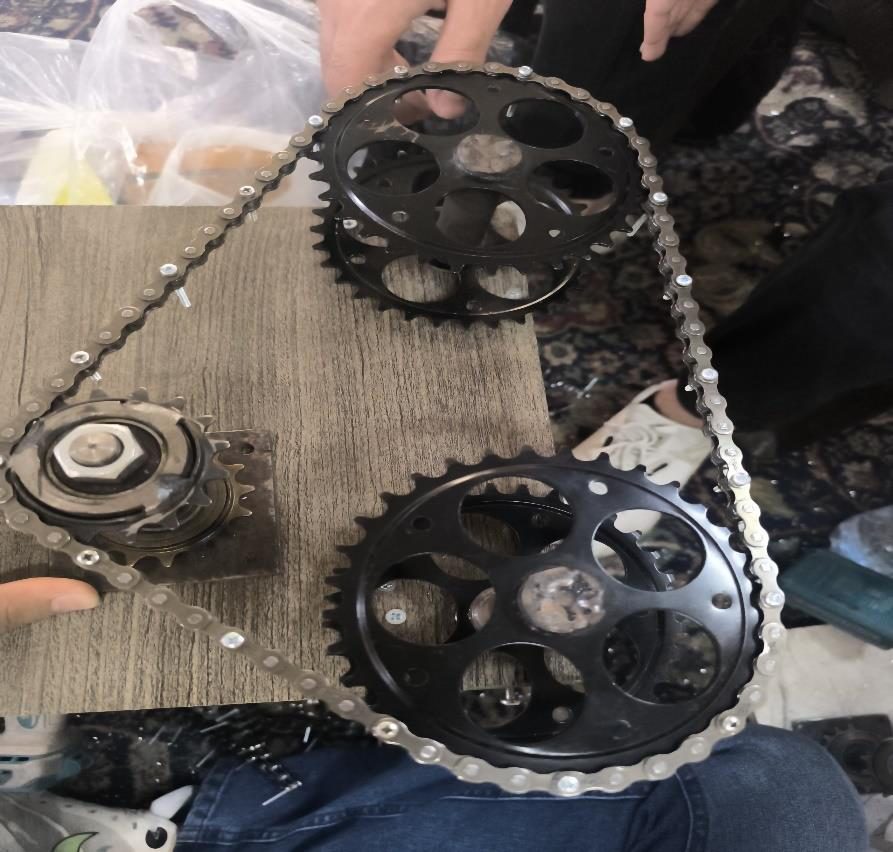 Track sprockets and chain laid out on the drive plate