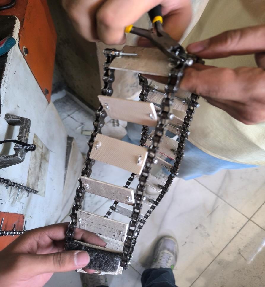 Tread plates being bolted onto a bicycle chain